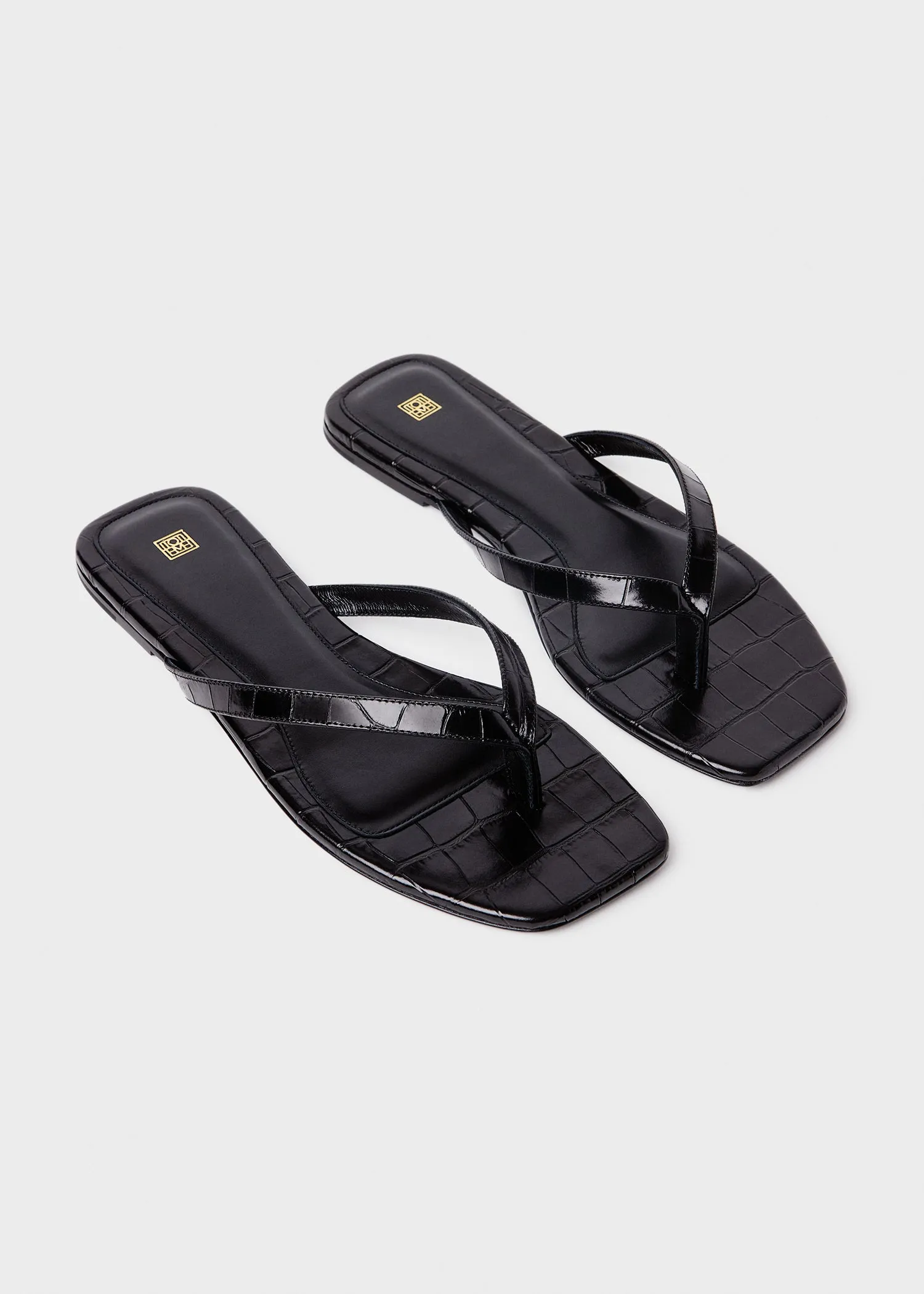 Croco-embossed flip flops black